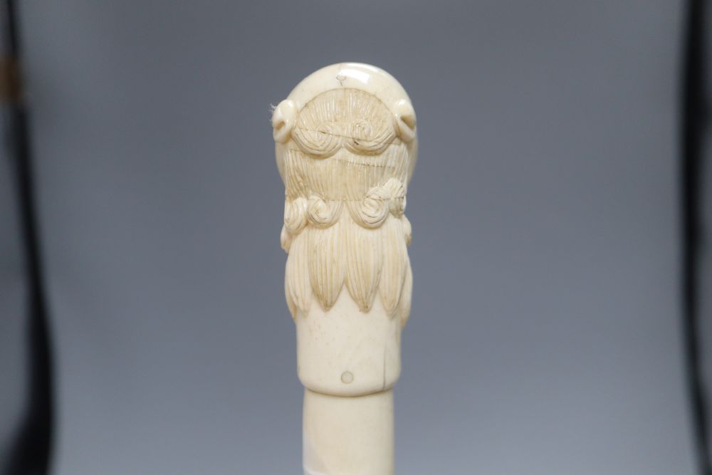 An Indian bone walking cane, with dog handle, c.1960, length 92cm